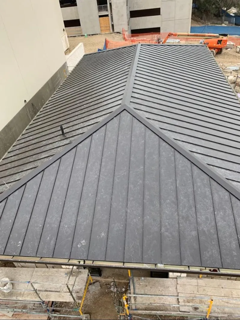 Commercial metal roof construction with crane equipment in Shamong